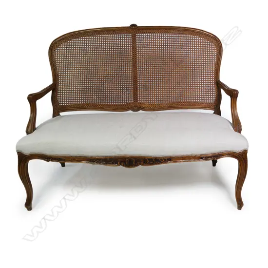 A French Louis XV style walnut framed, cane backed canapé,