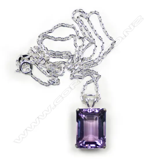 A silver and amethyst large pendant on chain,