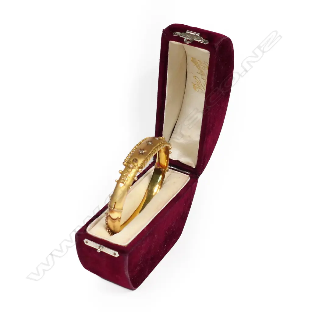 An early 20thC 9ct yellow gold and diamond snap bangle. Image 1++