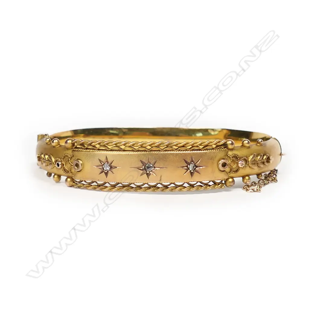 An early 20thC 9ct yellow gold and diamond snap bangle. Image 1++