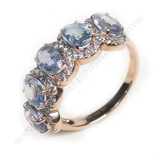 A 14ct rose gold, sapphire and diamond halo ring,