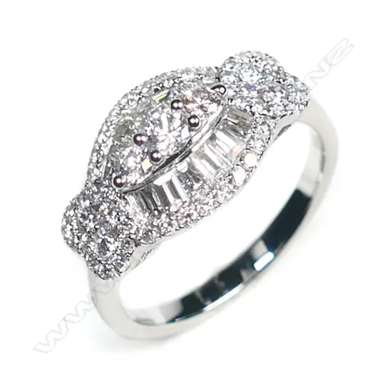 An 18ct white gold and multi diamond ring, formed as twin hearts flanking an oval section set with 53 brilliant and 13 tapered baguette cuts of TDW 1.02ct.