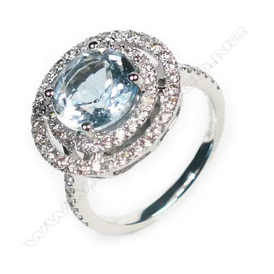 A 14ct white gold, aquamarine and diamond double halo ring,