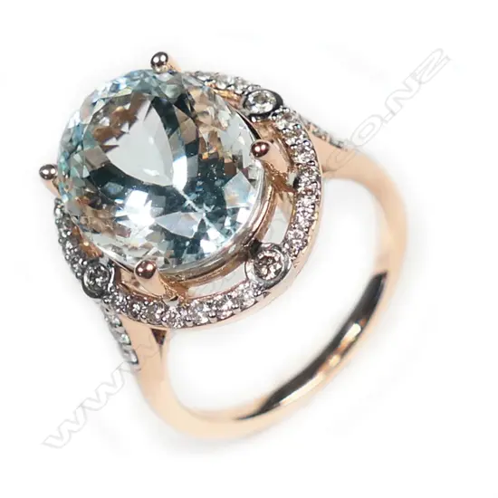 A 14ct rose gold, aquamarine and diamond vintage style halo ring,