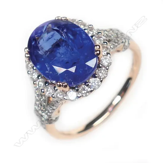 A 14ct rose gold, tanzanite and diamond vintage style halo ring,