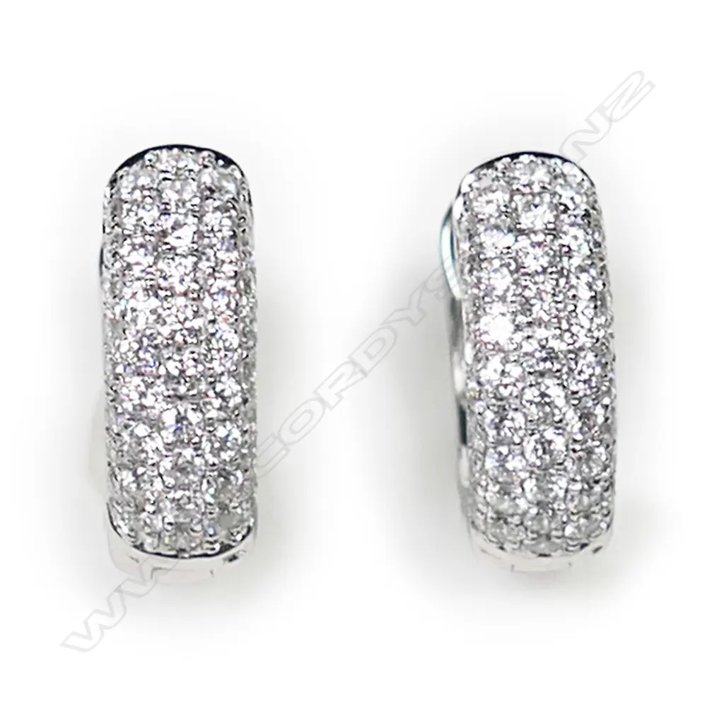 A pair of 18ct white gold and diamond huggie earrings, Image 1++