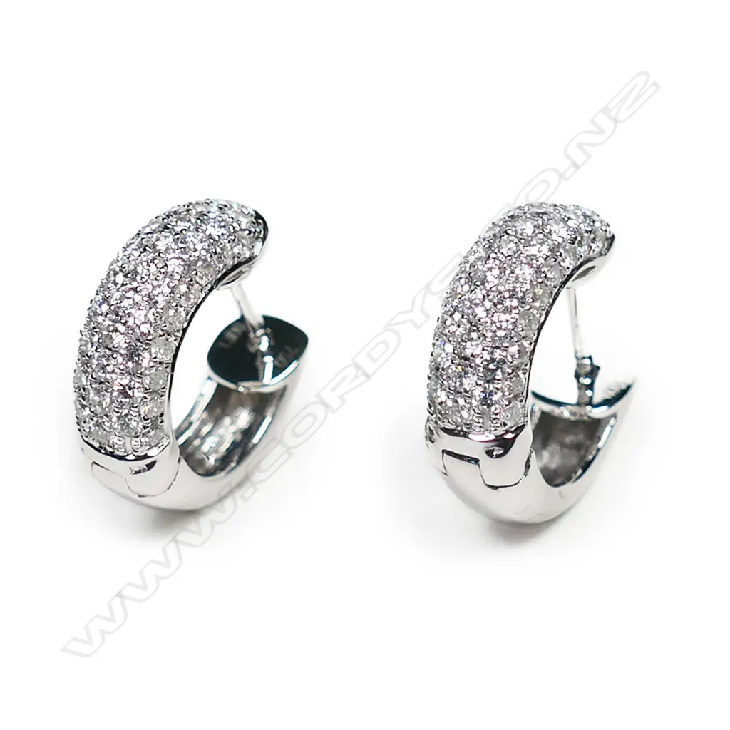 A pair of 18ct white gold and diamond huggie earrings, Image 1++