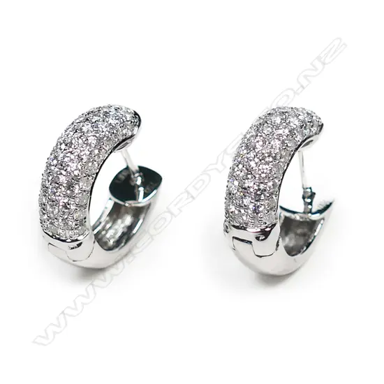 A pair of 18ct white gold and diamond huggie earrings,