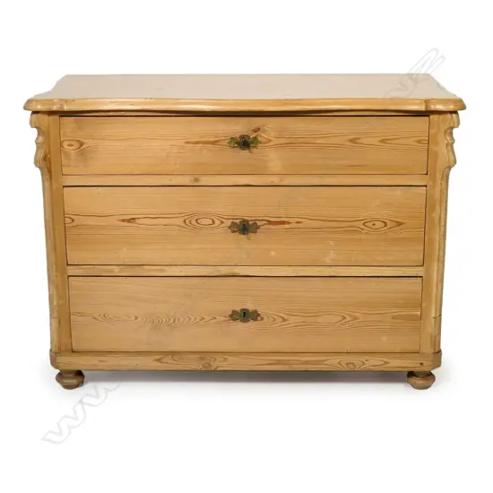 A European Biedermeier pine commode, of three graduated drawers,