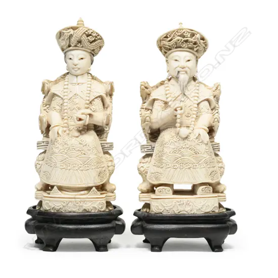 A pair of Chinese carved ivory Emperor and Empress figures,