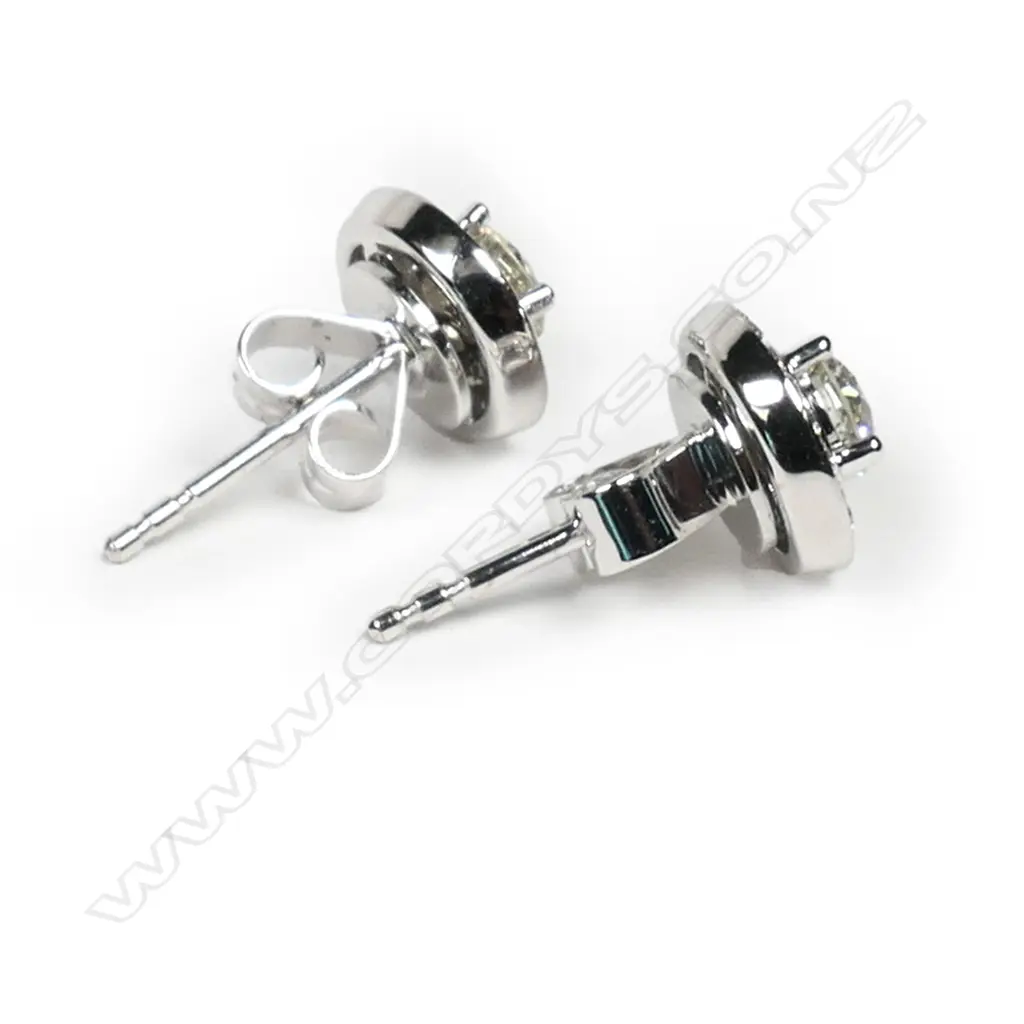 A pair of 18ct white gold and diamond stud earrings, Image 1++