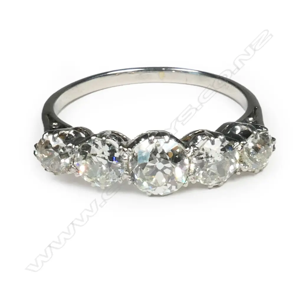 A c1920 platinum and five stone diamond bridge ring, Image 1++