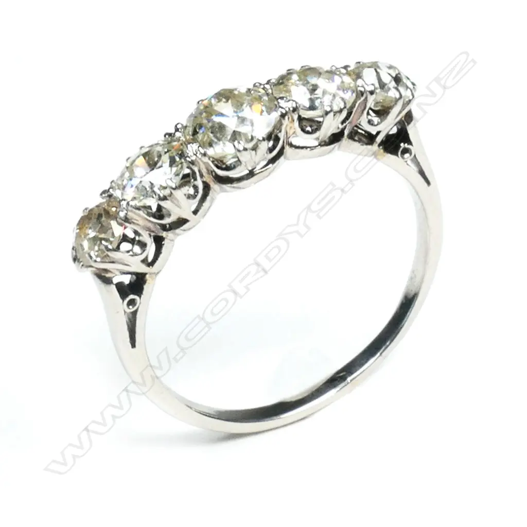 A c1920 platinum and five stone diamond bridge ring, Image 1++