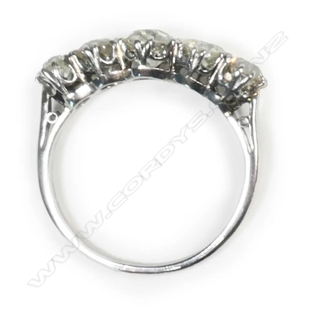 A c1920 platinum and five stone diamond bridge ring, Image 1++