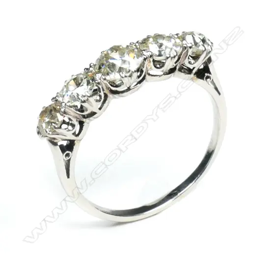 A c1920 platinum and five stone diamond bridge ring,
