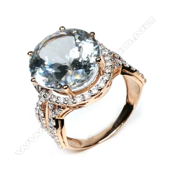 A 14ct rose gold, aquamarine and diamond halo cocktail ring,