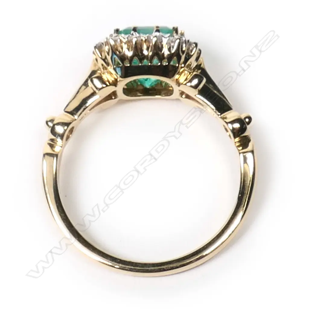 A 14ct gold, Colombian emerald and diamond halo ring, Image 1++