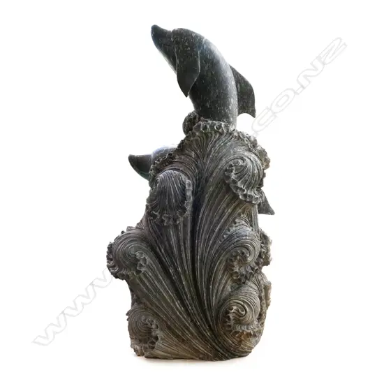 A large and impressive marble sculpture of dolphins frolicking in the waves,