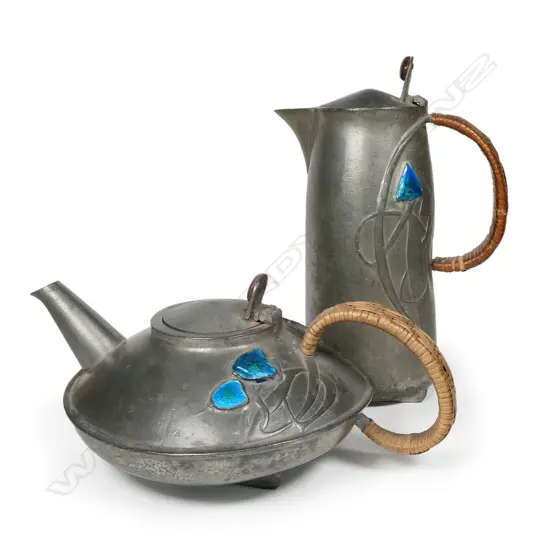 An Archibald Knox design Tudric pewter teapot and hot water pots,