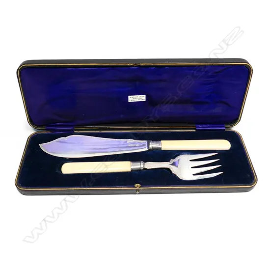 A set of ivory and silver fish servers,