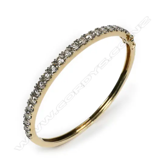 A 10ct gold and diamond set bangle,