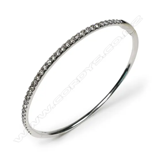 A 14ct white gold and diamond set bangle,