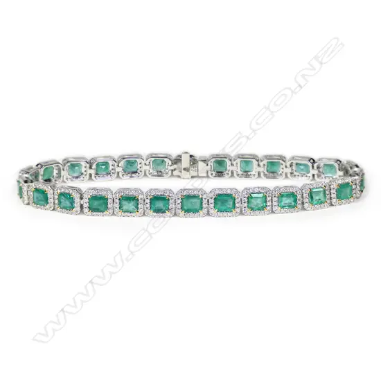 A 14ct white gold, emerald and diamond halo line bracelet,