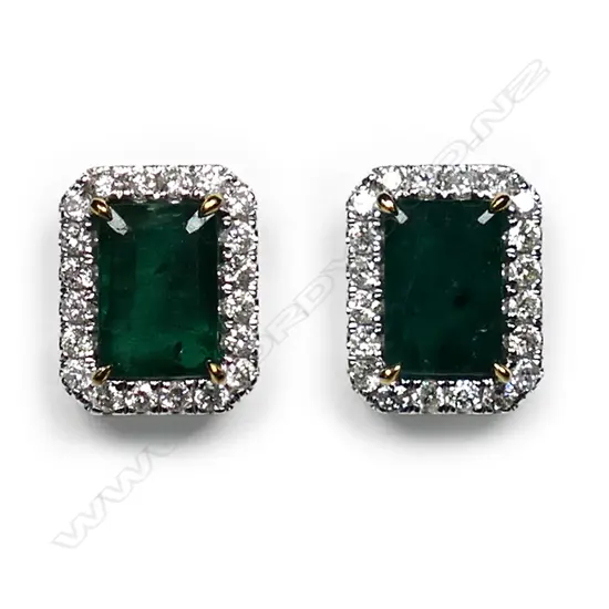 A pair of 14ct white gold, emerald and diamond halo stud earrings,