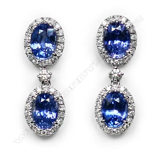 A pair of 14ct white gold, Ceylon sapphire and diamond halo drop earrings,
