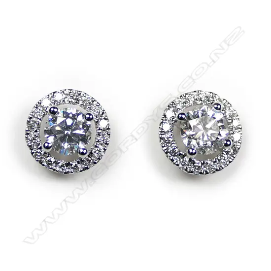 A pair of 18ct white gold and diamond round form earrings,