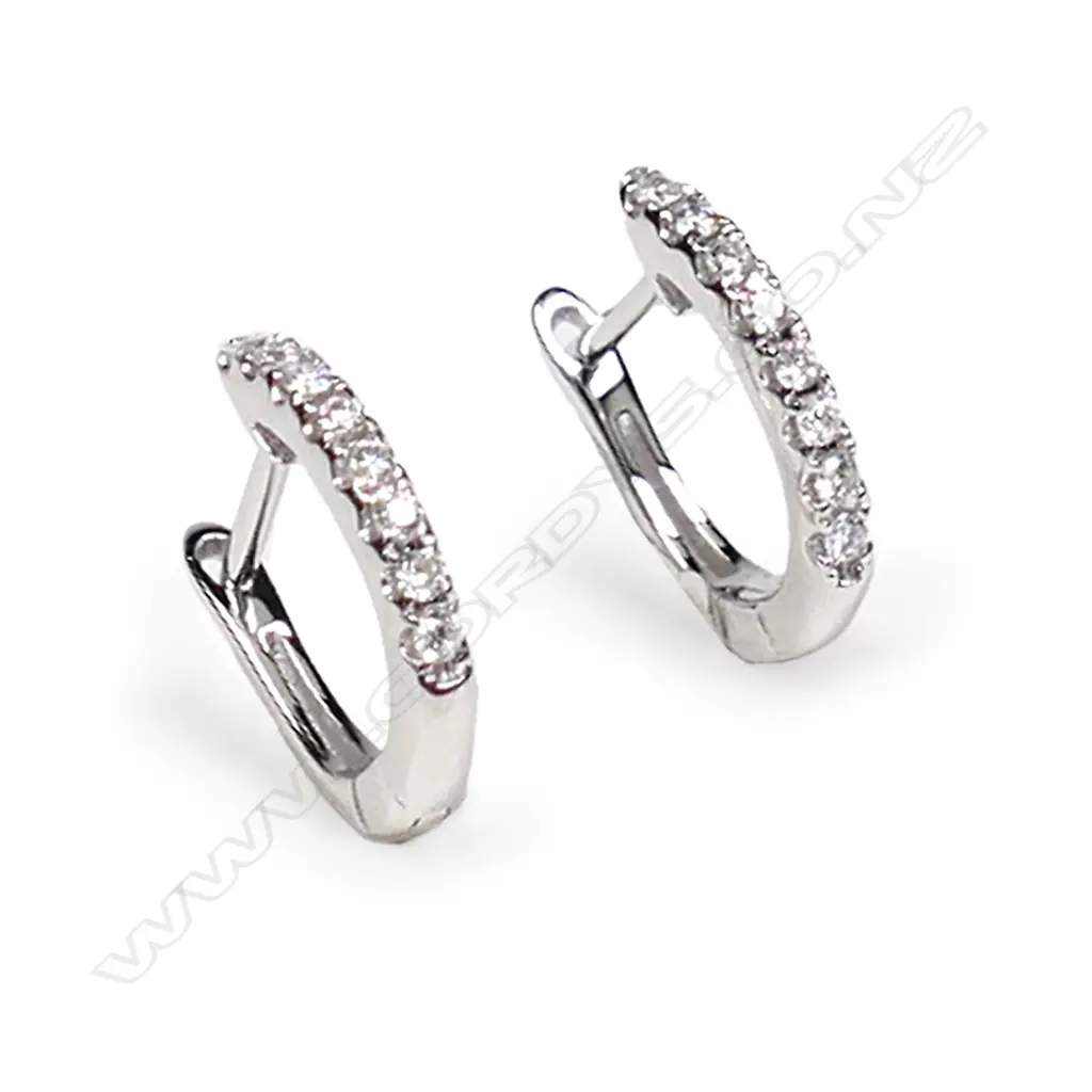 A pair of 18ct white gold and diamond huggie style earrings, Image 1++