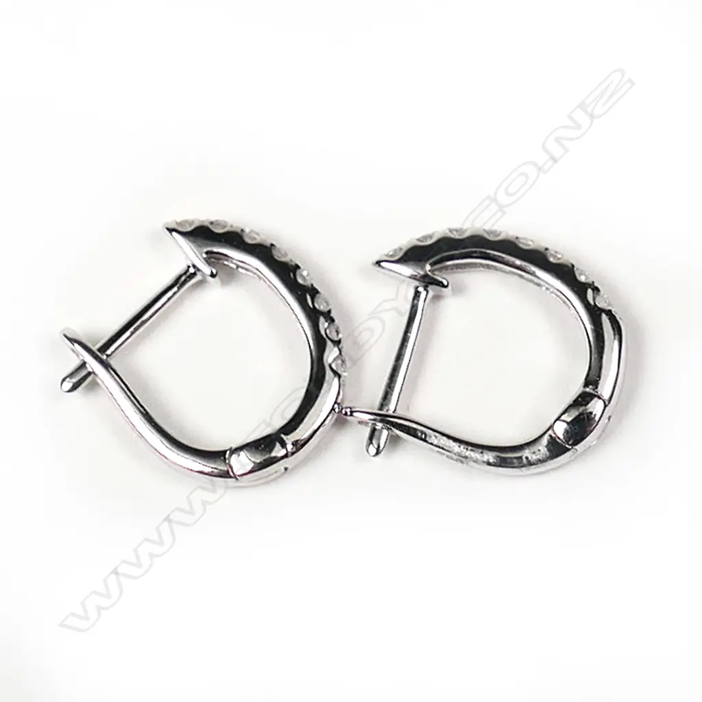 A pair of 18ct white gold and diamond huggie style earrings, Image 1++