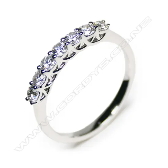 An 18ct white gold and seven diamond bridge ring,
