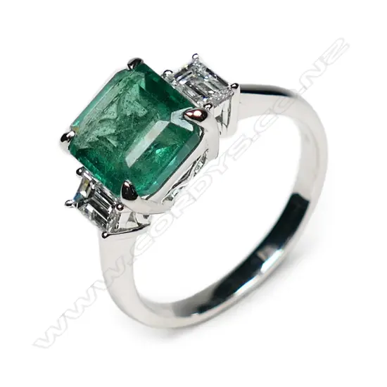 An 18ct white gold, emerald and diamond ring,