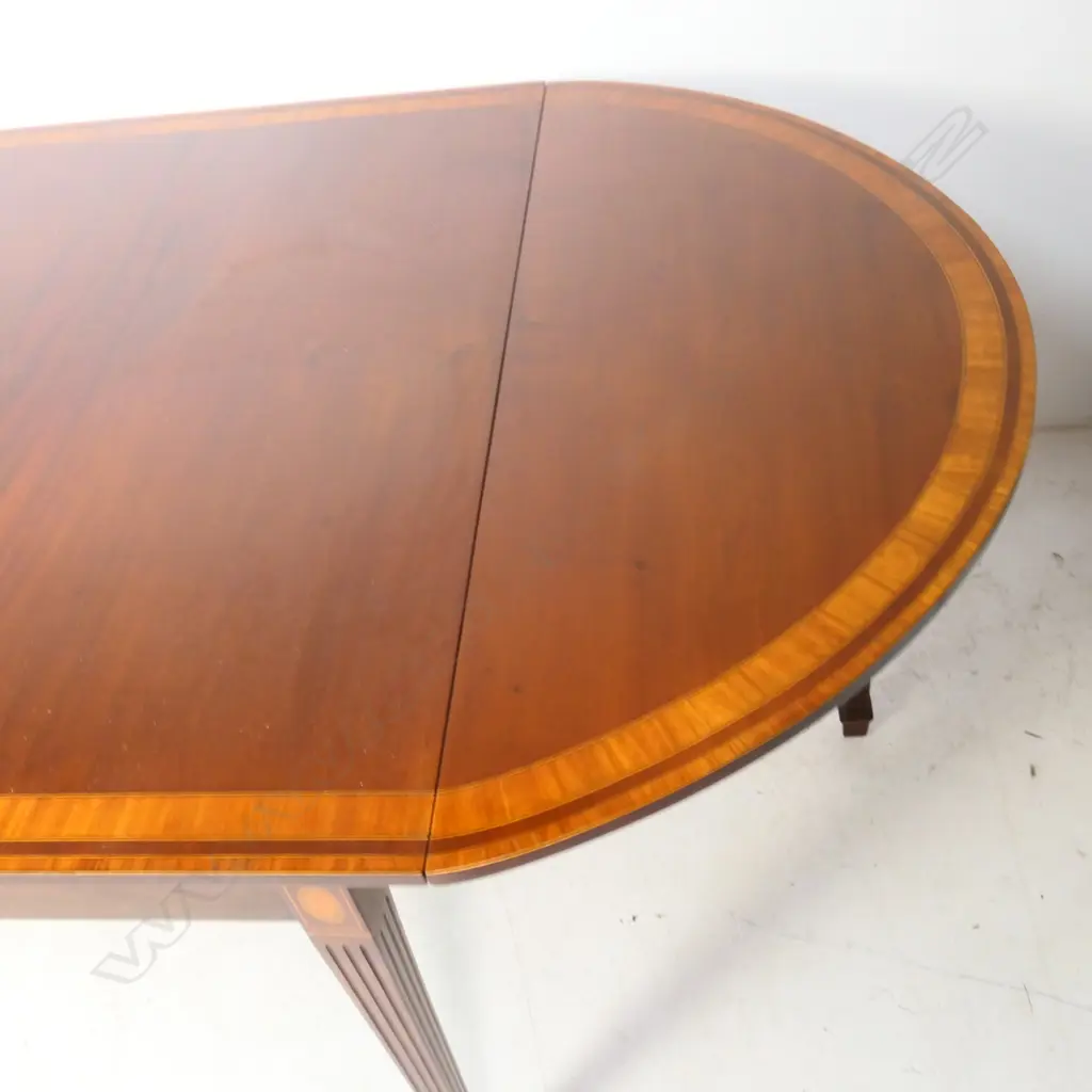 A Sheraton style mahogany drop leaf demi-lune ended dining table, Image 1++