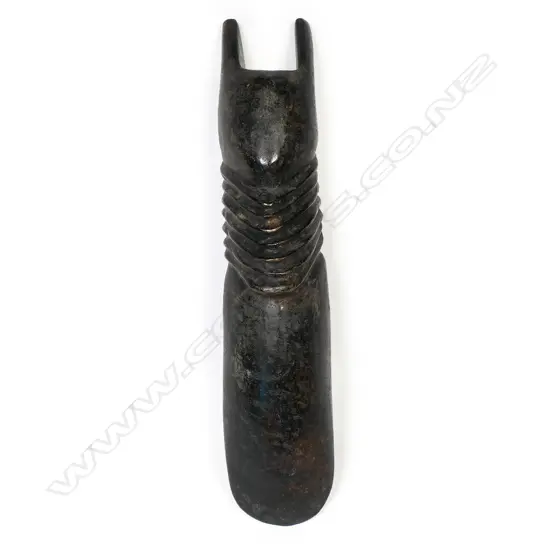 A large and decorative ceremonial adze blade,