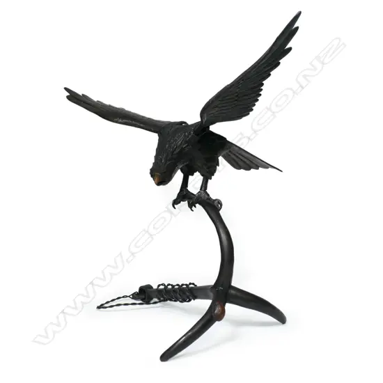 An early 20thC bronze hawk alighting upon anchor,