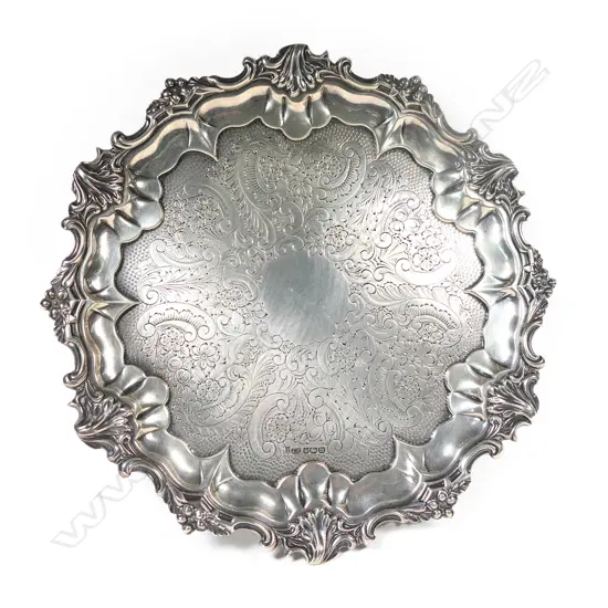 An Edwardian silver pie crust rim salver