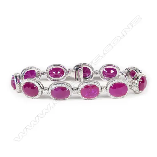 A platinum, ruby and diamond halo tennis bracelet,