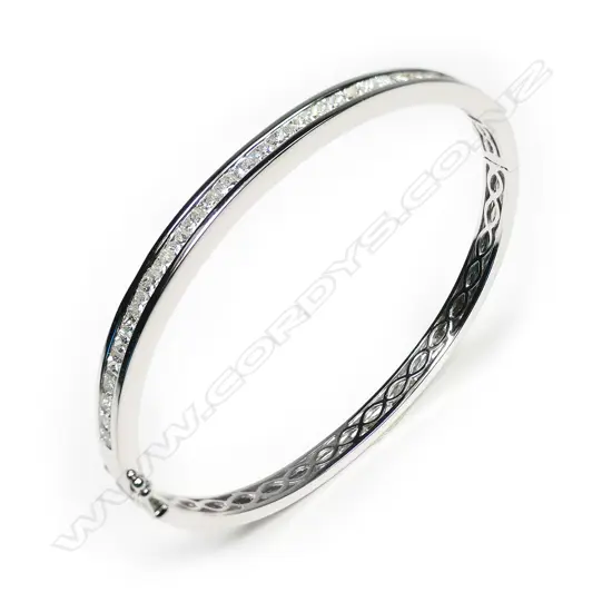 An 18ct white gold and diamond bangle,