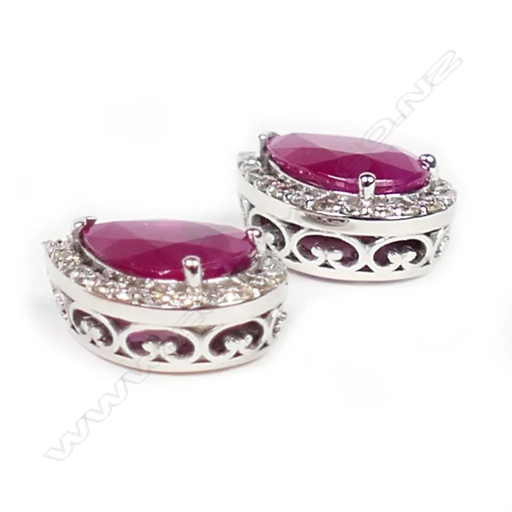 A pair of 14ct white gold ruby and diamond halo stud earrings, Image 1++