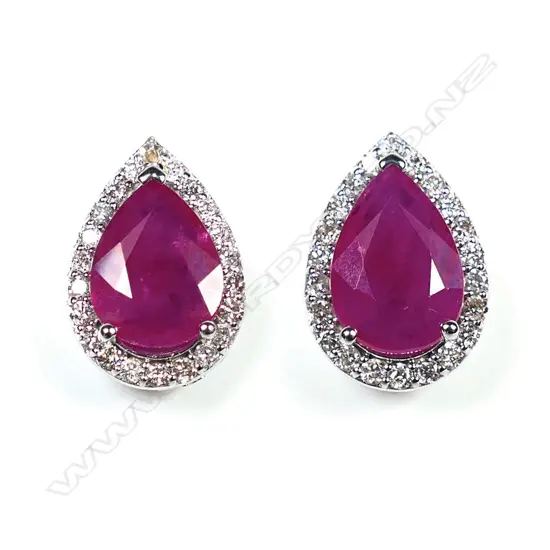 A pair of 14ct white gold ruby and diamond halo stud earrings,
