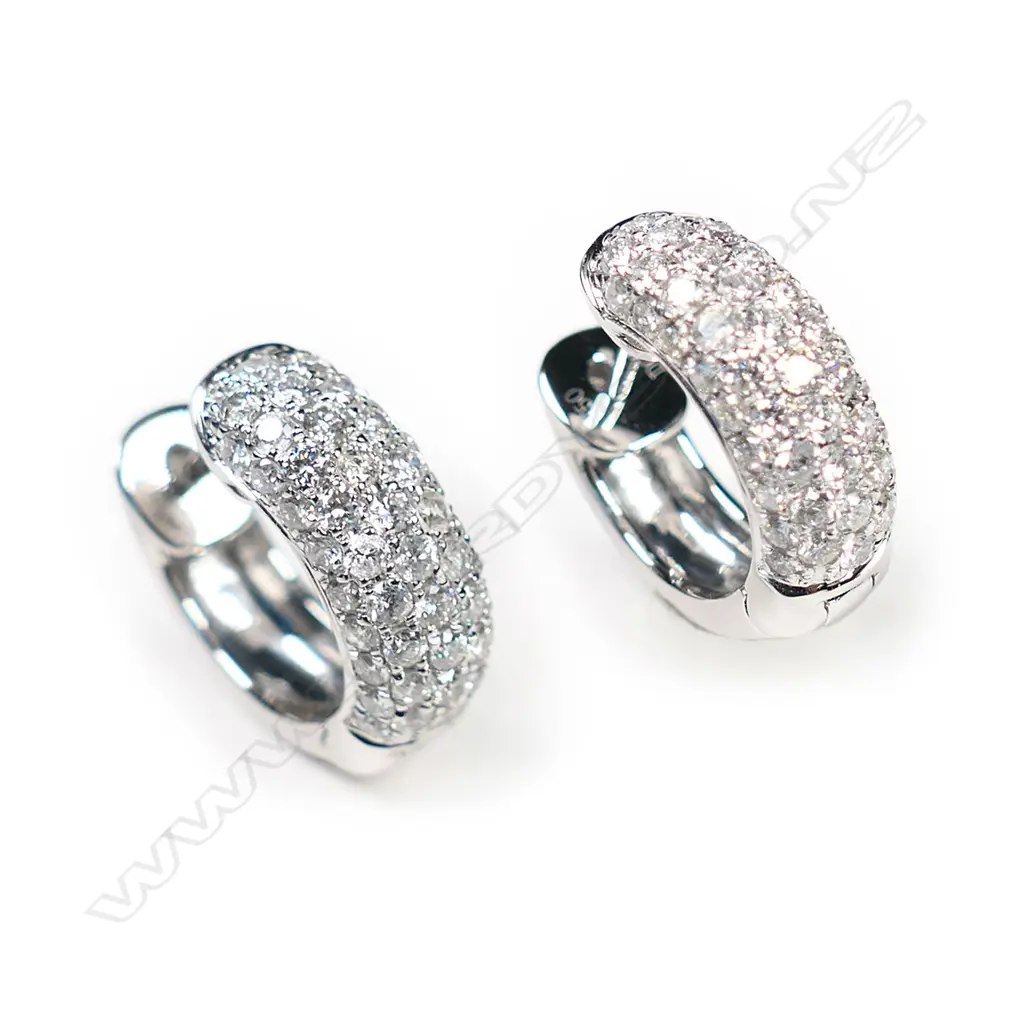 A pair of 18ct white gold and diamond huggie earrings, Image 1++