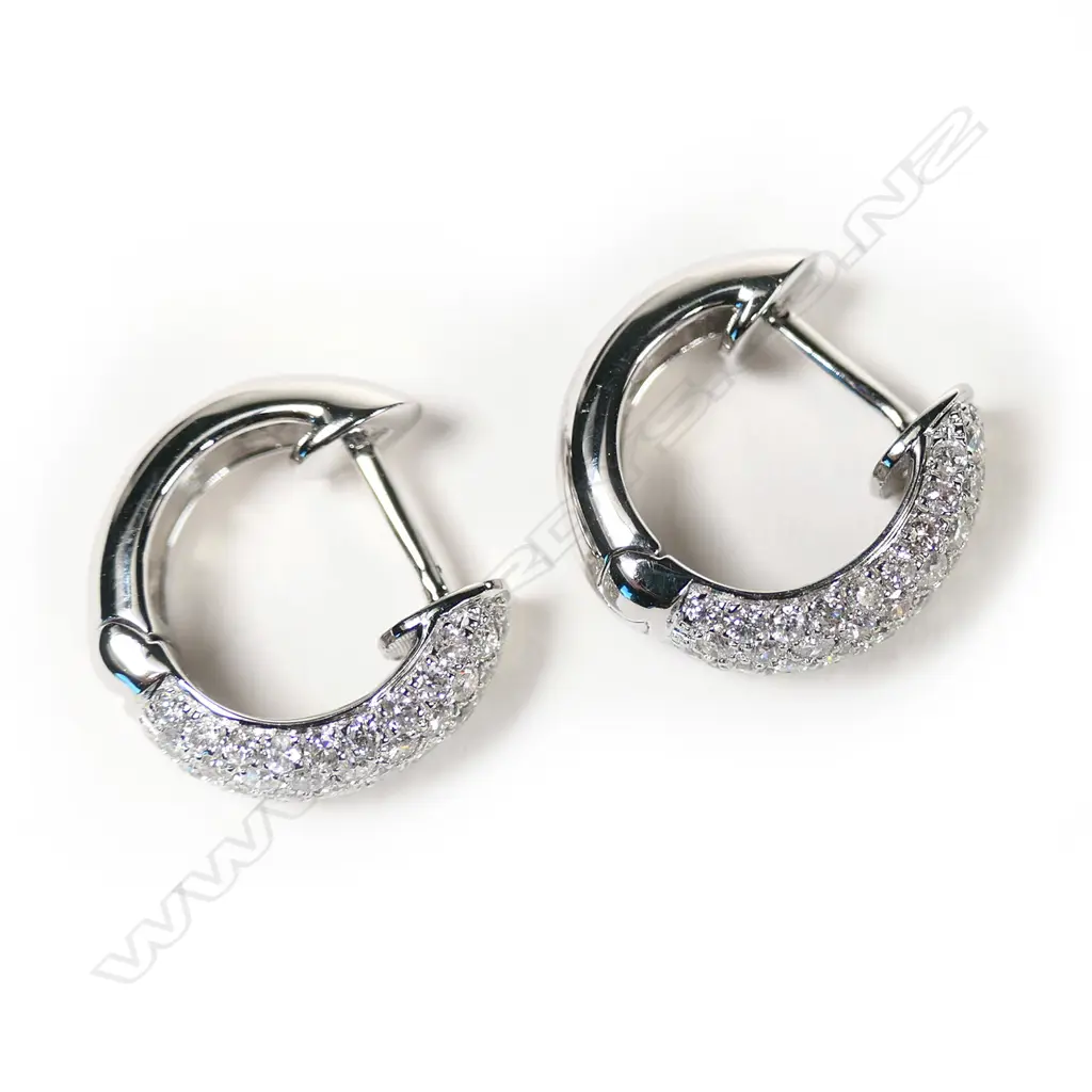 A pair of 18ct white gold and diamond huggie earrings, Image 1++