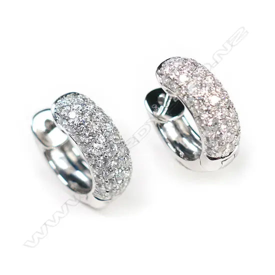 A pair of 18ct white gold and diamond huggie earrings,