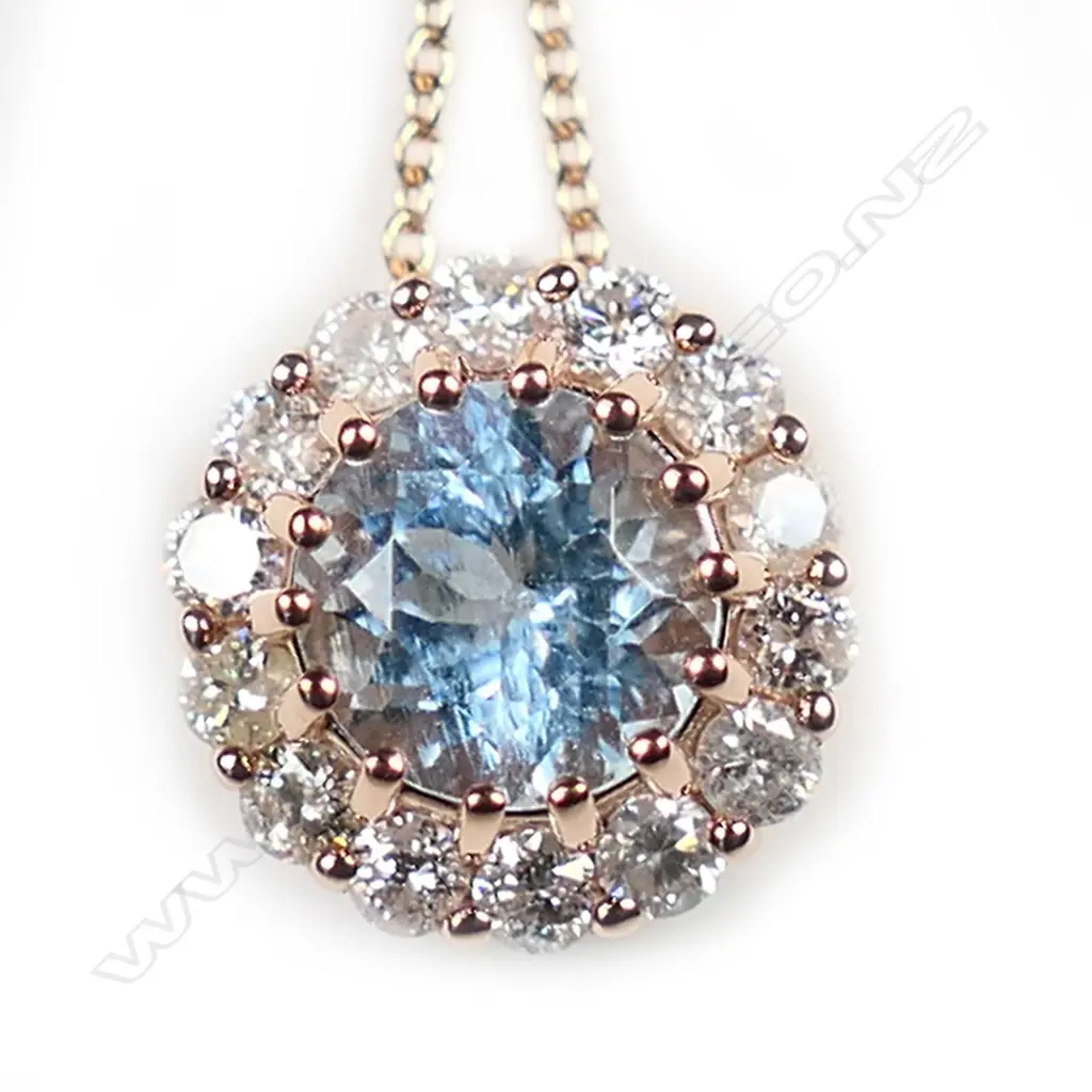 A 14ct rose gold aquamarine and diamond halo necklace, Image 1++