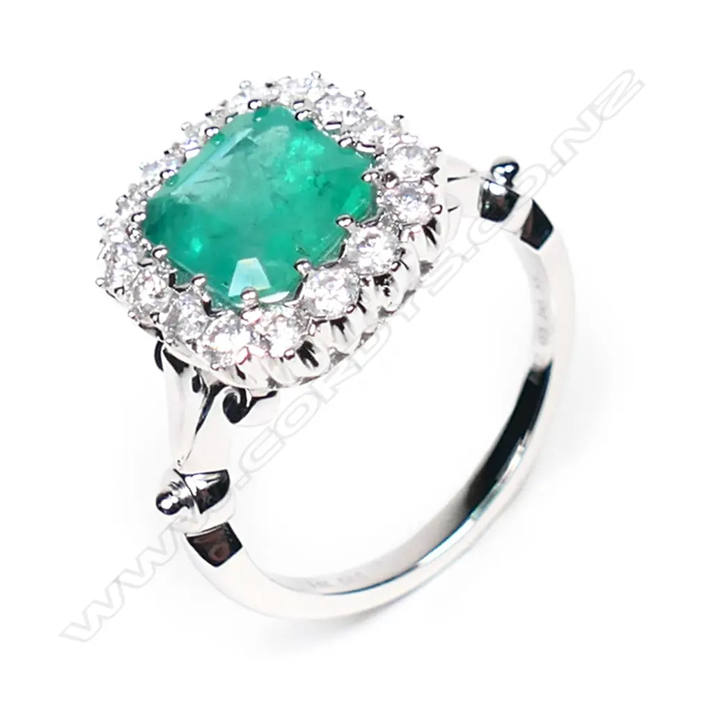 A 14ct white gold, emerald and diamond antique style halo ring, Image 1++