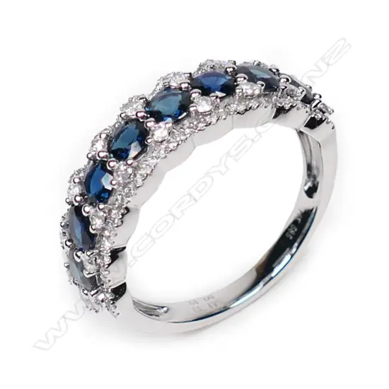 A 14ct white gold, sapphire and diamond halo eternity style ring,