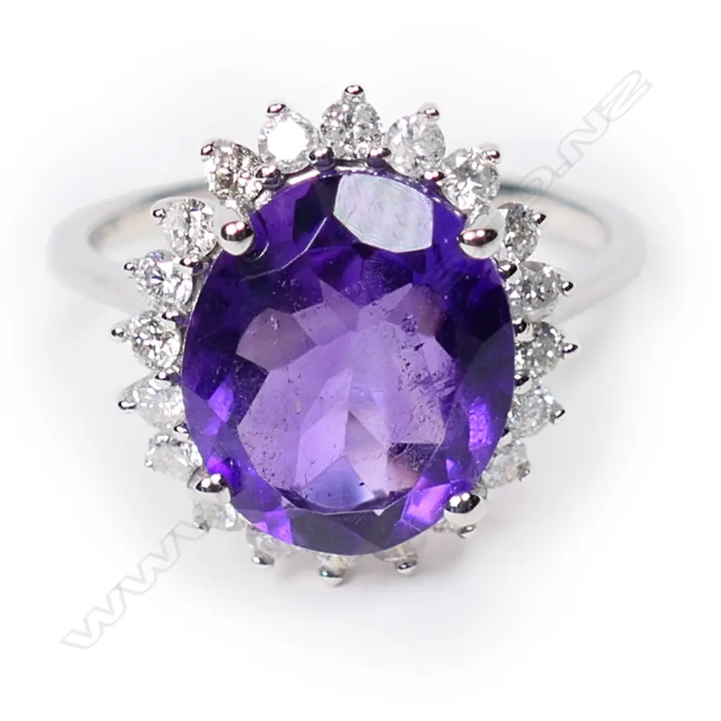 A 14ct white gold, amethyst and diamond halo ring, Image 1++