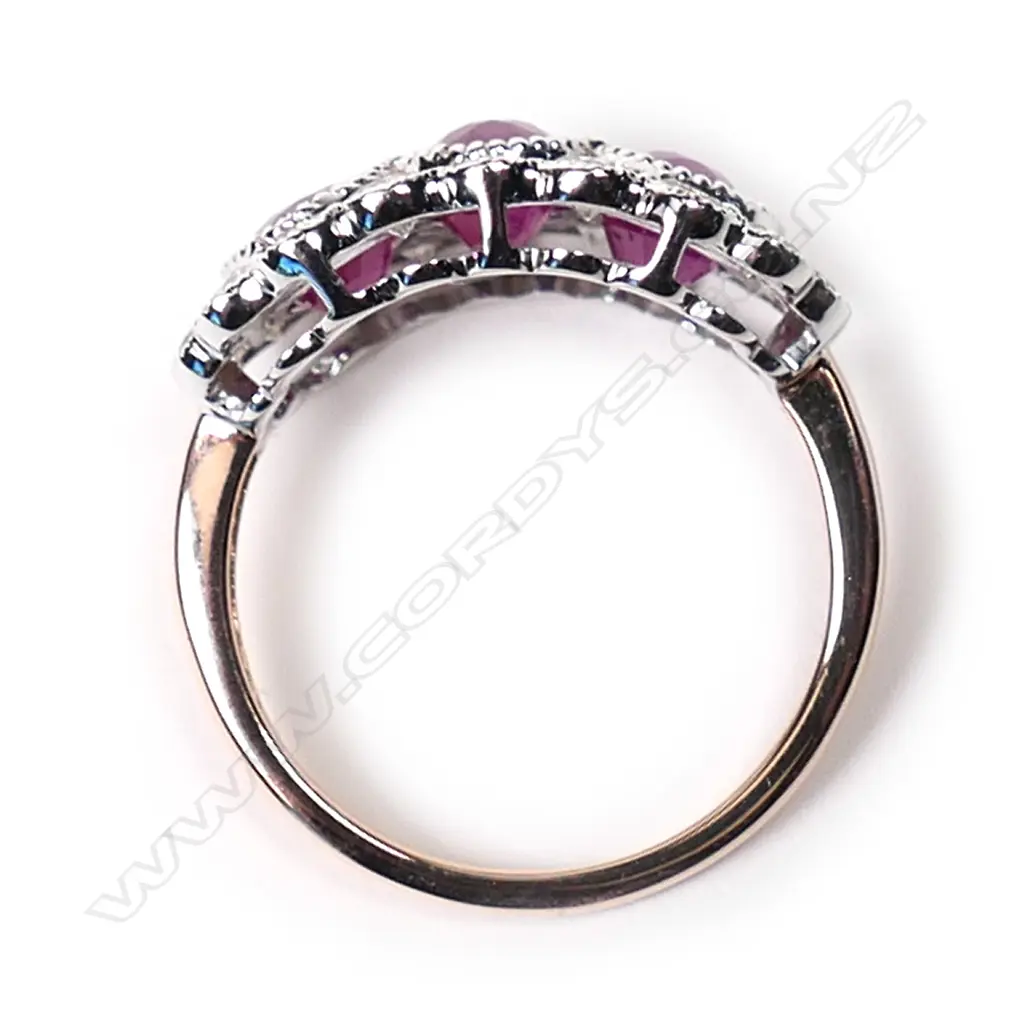 A 14ct rose gold, ruby and diamond trilogy ring, Image 1++